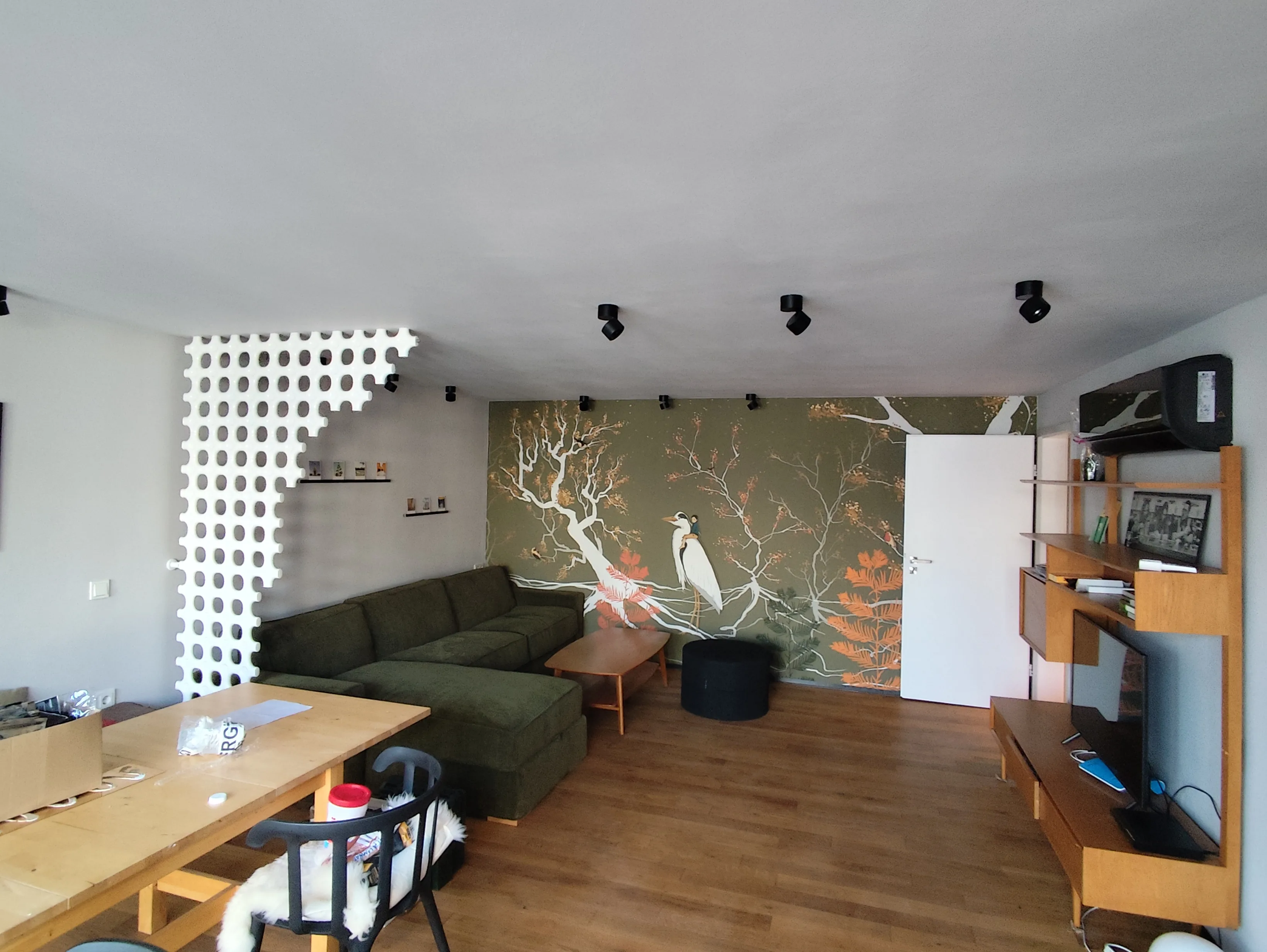 Moderner Wohnraum mit Sofa, dekorativer Wand und gemütlicher Beleuchtung